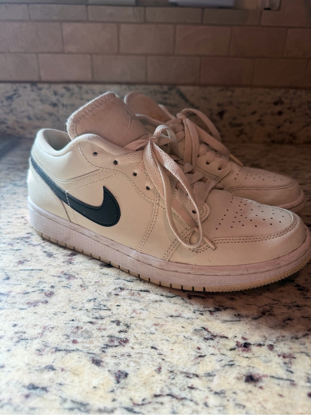 Nike Low-Top Sneakers in Cream with Black Swoosh
